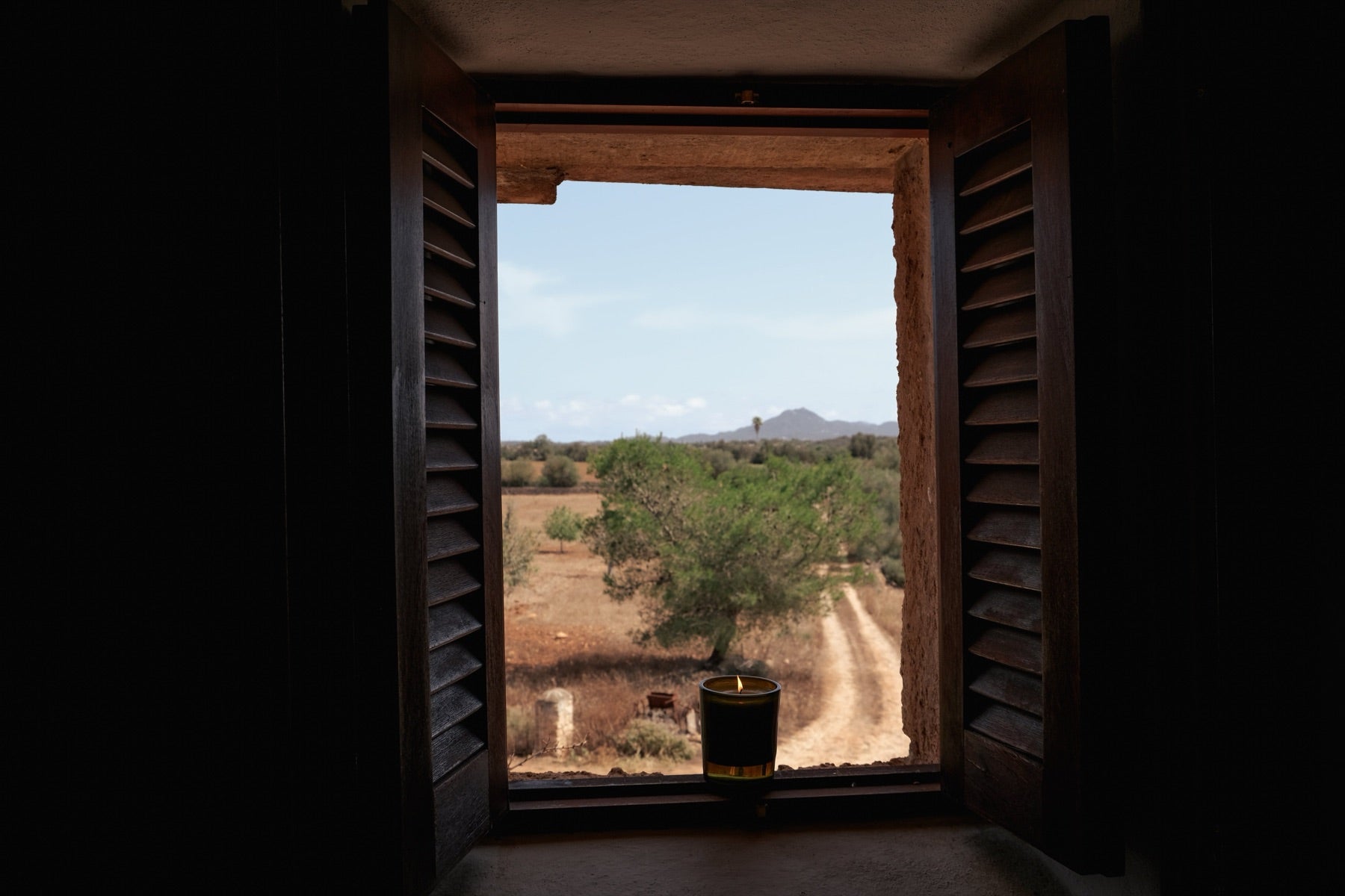 A Rotano candle on the farmhouse sill